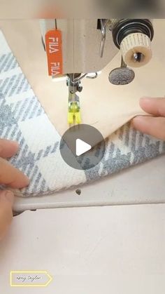 someone is using a sewing machine to sew something on a piece of fabric that has been stitched together