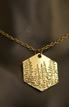 Embrace the timeless beauty of the forest with our Rustic Pine Tree Necklace. This charming piece is not just a necklace; it's a celebration of nature and the enduring majesty of pine trees. Nature-inspired Brass Necklace For Gift, Tree Necklace, Pine Trees, Pine Tree, Lake City, Salt Lake City, The Forest, Timeless Beauty, Pendant Necklaces