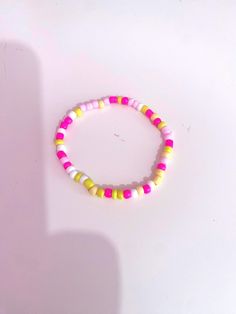 This is a pink lemonade theme bracelet. I made this by myself. Cute Handmade Yellow Beaded Bracelets, Handmade Trendy Yellow Bracelets, Trendy Handmade Yellow Bracelets, Trendy Pink Bangle Bracelet, Trendy Pink Bangle Bracelets, Pink Bracelets With Colorful Beads For Friendship, Trendy Pink Stretch Bangle Bracelet, Pink Casual Wristband, Sweet Pink Jewelry With Colorful Beads