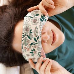 a woman laying on top of a bed wearing a neck tie