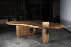 a wooden table sitting on top of a cement floor