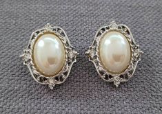 Vintage faux pearl clip on earrings made by 1928. Vintage jewelry from 1970s in great condition. Their reverse side has the well known unique 1928's patters. Chunky gold earrings for her. This pair is made of gold tone metal and plastic faux pearls. Would be a perfect treat to yourself or gifts for her. You'll enjoy wearing these beautiful earrings day or night. This classic design makes this pair universal, suitable for almost any outfit.  Sturdy clasps, nice strong grip. I think there were nev Chunky Gold Earrings, Large Pearl Earrings, Gold Tone Metal, Vintage Brooches, Vintage Necklace, Clip On, Beautiful Earrings, The Well, Clip On Earrings