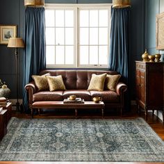 a living room filled with furniture and blue walls