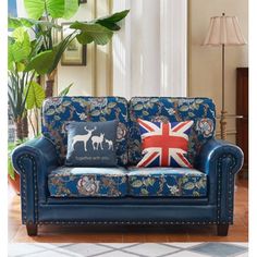 a blue couch sitting in front of a potted plant