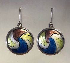 "Handmade one of a kind enamel and silver earrings. This set is fabricated from Argentium (anti-tarnish) sterling silver. They are each set with a free hand painted enamel to create a unique style. The enamel inserts are high fire vitreous enamel on fine silver. They are 1.375\" long by 7/8\" wide. They are hallmarked on the back. They have generous length 20ga (0.032\") ear wires and include silicon rubber retainers to keep them safe." Unique White Enamel Earrings, Multicolor Hand Painted Metal Jewelry, Hand Painted Enamel Jewelry Gift, Hand Painted Enamel Jewelry For Gifts, Hand Painted Multicolor Metal Jewelry, Unique Enamel Jewelry As Gift, Multicolor Sterling Silver Earrings For Gift, Soldered Enamel Drop Earrings, Nickel Free Enamel Dangle Earrings