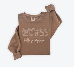 Embrace the cozy vibes of autumn with our 'Hello Pumpkin' Brown Comfort Colors Fall Crewneck. Crafted from premium cotton, this crewneck is your perfect companion for crisp fall days and pumpkin spice moments. Whether you're strolling through autumn foliage or enjoying a warm drink with loved ones, our crewneck offers comfort and style in every season. Key Features: Warm and Cozy: Made from soft Comfort Colors brand crewneck sweatshirts, 80% ring spun USA cotton, 20% polyester Charming Design: F Fall Iron On Designs, Cricut Fall Sweatshirt Ideas, Fall Loungewear Sweatshirt, Fall Everyday Cotton Sweatshirt, Cozy Fit Fall Sweatshirt, Soft-washed Cozy Fit Top For Fall, Cozy Fit Soft-washed Top For Fall, Fall Cotton Soft-washed Sweatshirt, Soft-washed Sweatshirt For Everyday Fall Wear