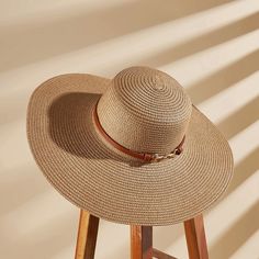 Beat the heat in style with the Women's Faux Leather Trim Wide Brim Straw Sun Hat. This chic and functional accessory is crafted from natural straw, offering breathable and lightweight protection from the sun's rays. The wide, floppy brim provides ample coverage for your face, neck, and shoulders, ensuring you stay cool and comfortable during outdoor adventures. Elevating the design is a sleek faux leather trim band that adds a touch of sophistication and a contrasting texture. Whether you're lo Adjustable Brown Straw Hat For Spring, Brown Flat Brim Straw Hat For Vacation, Trendy Straw Hat For Outdoor, Lightweight Brown Hat For Vacation, Trendy Brown Straw Hat For Spring, Chic Adjustable Outdoor Hats, Chic Adjustable Outdoor Hat, Brown Adjustable Straw Hat For Summer, Adjustable Brown Straw Hat For Summer