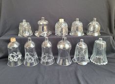 an assortment of clear glass objects on a black background