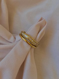 Elevate your style with our exquisite Mother of Pearl 18k gold plated stainless steel ring band. This stunning piece combines the elegance of Mother of Pearl with the luxury of 18k gold plating, creating a timeless accessory that will surely make a statement. Whether you're dressing up for a special occasion or simply adding a touch of sophistication to your everyday look, this gold ring is the perfect choice for any fashion-forward individual. Wavy Ring, Rings For Women Gold, Pearl Cocktail Ring, Gold Rings For Women, Minimalistic Outfits, Mother Of Pearl Ring, Layered Rings, Ring Der O, Ringe Gold