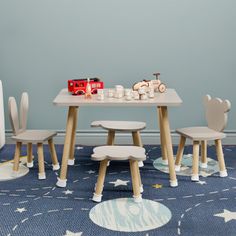 a child's table and chairs in a room