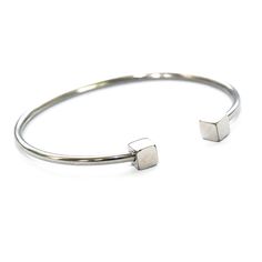 Gorgeous Rhodium plated steel bracelet with clean cubes at the handle. This bracelet compliments any wrist beautifully. The bracelet comes in two sizes but both are widely sizeable by pulling the string.Fit's up to a 7 inch wrist. Adjustable Stainless Steel Bangle In White Gold, Adjustable Nickel-free Minimalist Bangle, Modern Adjustable Nickel-free Bracelets, Adjustable Metal Bangle In Minimalist Style, Modern Adjustable Bracelets As Gift, Adjustable Minimalist Metal Bangle, Modern Stackable Metal Bracelets, Modern Metal Stackable Bracelets, Adjustable Minimalist Sterling Silver Bracelet Nickel Free