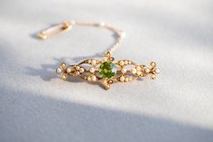 Edwardian peridot and seed pearl bar brooch. VIDEO https://youtu.be/2dqmfwkwrfE https://youtu.be/LcAQcLa-tuE DETAILS 15 carat yellow gold. Brooch width 5cm, length 2cm, weight 5.2g. CONDITION REPORT Pre-owned,  Overall condition excellent  HALLMARKS: tbc LIKE IT? Make a perfect vintage GIFT!  All our jewellery comes beautifully packed in one of the Kashovska Vintage Collection original boxes. However if you would like to pair your vintage pendant with an authentic antique box you can some amazin Antique Boxes, Green Gemstones, Vintage Jewellery, Vintage Gifts, Gifts For Wife, Gemstone Jewelry, Jewelry Accessories, Accessory Gift, Gemstones