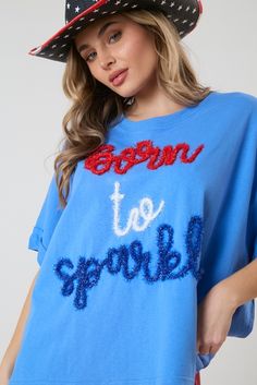 This Lurex Thread Embroidery Top is a dazzling and stylish addition to your wardrobe. Crafted with shimmering lurex thread embroidery, this top exudes glamour and sophistication. Its vibrant blue color adds a pop of personality, while the "Born To Sparkle Blue T-shirt With Embroidered Text For Spring, Blue Glitter Print Crew Neck Tops, Blue Crew Neck Tops With Floral Embroidery, Blue Floral Embroidered Crew Neck Top, Blue Crew Neck Top With Floral Embroidery, Blue Crew Neck Tops With Glitter Print, Cotton Glitter Print Party Tops, Party Cotton Tops With Glitter Print, Blue Tops With Embroidered Text For Spring