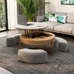 a living room filled with furniture and a laptop computer on top of a coffee table