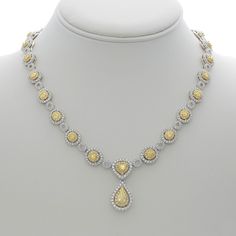 Navigate the nuances of elegance with our Hanging Pear Two Tone Diamond Necklace. Crafted for the soulful romantic in you, this necklace embodies the perfect blend of sophistication and allure. Picture this: glistening white and yellow diamonds, totaling a mesmerizing 13.12 carats, grace the entire neckline of this exquisite 18K gold masterpiece. Amidst the cascade of diamonds, a resplendent pear-shaped yellow diamond steals the spotlight, casting a warm glow that captures the heart.Imagine adorning yourself with this necklace, the embodiment of timeless love and captivating grace. The pear-shaped yellow diamond, delicately prong-set, hangs gracefully from the center, embraced by a halo of dazzling white diamonds. Each facet of this pendant tells a story, a tale of love and passion that li Luxury Pear-shaped Drop Necklace For Wedding, Formal Pear-shaped Necklace With Diamond Accents, Formal Drop Necklace With Brilliant Cut, Fine Jewelry White Necklaces With Sparkling Stones, Luxury Pear-shaped Drop Necklace For Anniversary, Formal White Gold Drop Necklace, Formal White Gold Drop Necklaces, Luxury Wedding Drop Necklace With Diamond Accents, Elegant Pear Shaped Necklace With Diamond Accents