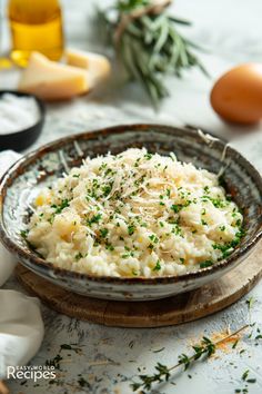 mashed potatoes with parmesan cheese and herbs in a bowl