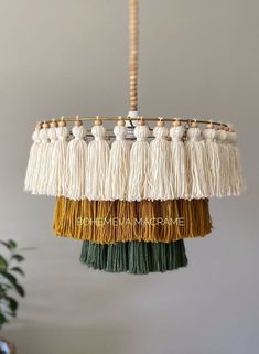 a chandelier with tassels hanging from it's sides in a room