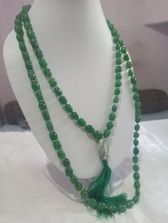 108 Beads AAA 968 Carat Emerald Dyed Japa Mala Prayer Green Color Oval Beads Japa Mala Guru bead Necklace // Long Tassel Necklace// Meditation japa mala // Guru bead// Necklace Yoga Beads Stone - Emerald Dyed Shape - Oval Size - Approx - 10x12mm Colour - Green It is known as the 'love stone' as the message it emits is the strong vibration of unconditional love, joy, warmth and healing. As quartz crystals are profound amplifiers of energy, it may help to kindle happiness, love, romantic feelings Traditional Hand-strung Jade Beaded Necklace, Gemstone Beads Rosary For Meditation, Traditional Jade Beaded Necklaces With Gemstone Beads, Green Gemstone Beads Mala For Healing, Spiritual Hand-strung Jade Beaded Necklace, Bohemian Necklace With Oval Faceted Beads, Bohemian Beaded Necklace With Faceted Oval Beads, Traditional Handmade Jade Beaded Necklaces, Elegant Healing Rosary With Round Beads