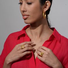 Introducing the epitome of refined elegance, our Round Wave Ring captivates with its timeless allure and mesmerizingly irregular textured gold surface, skillfully handcrafted to accentuate every facet of its inherent beauty. For a seamless transition from daytime chic to evening opulence, allow this resplendent piece to effortlessly elevate your ensemble. Pair it with a breezy linen sundress for a leisurely brunch or adorn your wrist with a sleek silk gown as you dance the night away at an exclusive soirée—the possibilities are as endless as the allure this exquisite ring exudes. Indulge in the sheer indulgence of ultimate sophistication—adorn your finger with this stunning Round Wave Ring and revel in the luminous fusion of classic charm and contemporary allure it brings to your every out Edgy Rings, Linen Sundress, Big Ring, Velvet Gown, Chunky Ring, Timeless Luxury, Wave Ring, Contemporary Ring, Seamless Transition