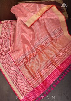 The Banarasi Silk Brocade sarees are a treasured Handloom that portray history and rich craftsmanship! This saree comes in a Peach Pink shade with gold and  Silver blending beautifully in this interweave of silk and zari! The red Kadhiyal  Border with zari makes the saree more charming. SILK MARK CERTIFIED The saree is ready to wear with falls and pico done. Hand knotted tassels add charm.  An unstitched blouse fabric is included. *Note: There may be minor variations in the shade, the texture of Transitional Pre-draped Slub Silk Saree, Transitional Slub Silk Traditional Wear With Zari Work, Festive Banarasi Silk Pre-draped Saree With Self Design, Festive Slub Silk Sharara, Semi-stitched Pre-draped Saree With Zari Weaving For Navratri, Slub Silk Pre-draped Saree With Cutdana For Navratri, Eid Semi-stitched Slub Silk Pre-draped Saree, Festive Semi-stitched Slub Silk Pre-draped Saree, Anarkali Style Raw Silk Pre-draped Saree With Self Design