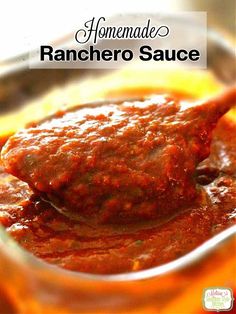 homemade ranchero sauce in a glass bowl with a spoon full of it and the title overlay reads homemade ranchero sauce