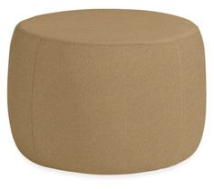 a tan ottoman that is sitting on top of a white surface and it's made out of fabric