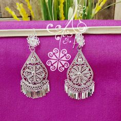 Beautiful and stunning handmade Mexican Filigree Earrings. Each piece is meticulously created out of copper wire and spun into a beautiful design. To give it the final touch artisans dipped into silver plate for it's elegant silver color. This accessory is an important part of the traditional Tehuana outfit from Oaxaca, Mexico. Look elegant while wearing Mexico's culture with this one of a kind earrings! Approximate length: 3.5-4 in Need more than one? Ask us about our combined flat rate shipmen Mexican Earrings, Mexico Culture, Filigree Earrings, Final Touch, Wedding Earrings, Copper Wire, Beautiful Earrings, Silver Color, Beautiful Design