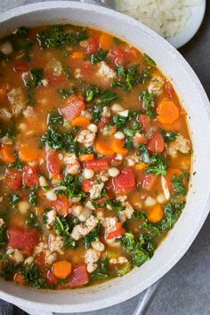 a white bowl filled with soup and vegetables