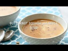 two bowls filled with soup on top of a blue and white table cloth next to spoons