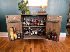 a wooden cabinet filled with lots of liquor bottles