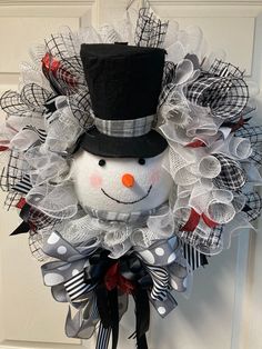 a wreath with a snowman wearing a top hat