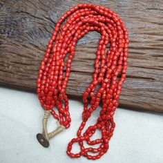 This vintage necklace features beautiful red and orange glass beads in a four-strand design. The unique beaded style and quality craftsmanship make this piece a one-of-a-kind addition to any jewelry collection. Made in India, this necklace showcases the cultural artistry of the region and is a perfect collectible item for those interested in unique and rare pieces. Perfect for any occasion, this necklace is sure to catch the eye and add a touch of elegance to any outfit. Vintage Orange Necklace With Colorful Beads, Vintage Orange Necklace With Faceted Beads, Vintage Hand-strung Orange Beaded Necklace, Vintage Red Hand-strung Beaded Necklaces, Star Beauty, Orange Amulet-style Jewelry With Large Beads, Glass Beads Jewelry, Red And Orange, Glass Bead Necklace