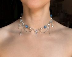 This handmade beaded Blue Fairy Necklace is made with glass, acrylic, and resin beads, with stainless steel chains.  ✧ Size: 12 inches with a 2-inch extender (adjustable to 14 inches). Perfect for those with a petite neck. If you need a larger or smaller size, message me with your desired measurements! I can add more beads and/or a second extender.  ✧ Closure: Lobster claw ✧ Care: For longevity, please keep away from water and perfumes. If you have any questions, feel free to reach out ♡ For more, visit my shop: https://www.etsy.com/shop/stardropstop Fairy Beaded Necklace, Necklace Reference, Coquette Necklace, Necklace Fairycore, Cottagecore Jewelry, Reference Ideas, Necklace Inspiration, Diy Necklaces, Y2k Necklace