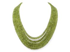 An 18K white gold multi-strand peridot bead necklace set with an elongated cabochon ruby and pavé diamond clasp. Metal: 18K White Gold Gemstone: Peridot: 985 carats Gemstone: Ruby: 10.58 carats Gemstone: Diamonds: 0.26 carats Design Era: Contemporary Elegant Peridot Round Beads Jewelry, Peridot Gemstone Beads Jewelry, Elegant Lime Green Faceted Jewelry, Elegant Green Beaded Gemstones, Elegant Green Faceted Beads Gemstones, Elegant Green Gemstones With Faceted Beads, Formal Multi-strand Faceted Bead Jewelry, Elegant Lime Green Beaded Jewelry, Elegant Lime Green Jewelry With Round Beads