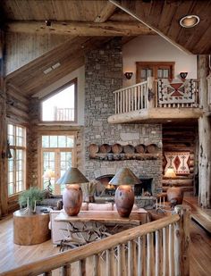 a living room filled with furniture next to a fire place in a wooden floored area