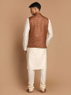 VASTRAMAY Men's Coffee Brown Nehru Jacket With Cream Solid Kurta And Pyjama Set This stylish men's coffee brown Nehru jacket paired with a cream solid kurta and pyjama set offers a classic yet contemporary look suitable for various occasions. Key Features: Includes a coffee brown Nehru jacket Cream solid kurta with intricate detailing Matching pyjama for a complete ensemble Comfortable and stylish design Specifications: Brand: VASTRAMAY Color: Coffee Brown, Cream Material: Cotton Blend Size: Ava Brown Kurta For Eid, Formal Long Sleeve Brown Kurta, Brown Fitted Nehru Jacket For Winter, Festive Long Sleeve Brown Kurta, Brown Long Sleeve Nehru Jacket For Winter, Brown Formal Sets For Festive Occasions, Formal Brown Sets For Festive Season, Formal Brown Festive Sets, Festive Formal Brown Sets