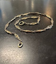 10k watch chain early 1900s, unusual decorative links.  Condition I see no problems, spring ring works.  Length 12", width approx. 3.5mm, wt.- 4.8 grams.  Such a finely made design, serrated open diamond shape Links with double twisted bars in center.  Fine quality! Vintage Yellow Gold Chain Bracelet With Rectangular Links, Vintage 14k Gold Necklace With Adjustable Chain, Vintage 14k Gold Chain Link Bracelet, Vintage Yellow Gold Chain Bracelet, Elegant Engraved Chain Link Jewelry, Vintage Silver Chain Necklace With Delicate Chain, Vintage Silver Delicate Chain Necklace, Vintage Yellow Gold Oval Link Chain Bracelet, Formal Engraved Link Chain Necklace