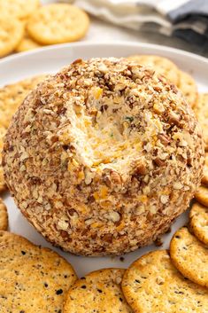 a cheese ball on a plate surrounded by crackers