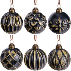 black and gold ornaments are hanging from strings