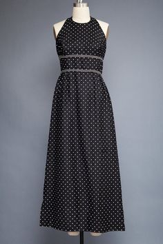 ♦ vintage 70s maxi dress ♦ halter with hooks + eyes strap at back of neck ♦ black with white polka dot ♦ empire double waist band and gathered skirt ♦ back nylon zipper, unlined    ----- Measurements (taken flat across garment)  Bust : 37 Waist : 28 Hips : 47 Length: 55 Sleeve length: - Tag: - Note Fitted Polka Dot Maxi Dress, Fitted Halter Neck Lined Maxi Dress, Fitted Polka Dot Maxi Dress For Spring, Chic Fitted Maxi Dress With Empire Waist, Summer Evening Polka Dot Maxi Dress, Summer Polka Dot Dresses With Fitted Bodice, Polka Dot Maxi Dress For Summer Evenings, Summer Black Maxi Dress With Fitted Bodice, Fitted Full-length Maxi Dress For Daywear