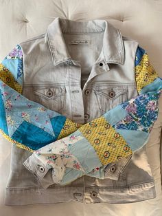 an old jean jacket with patchwork on it