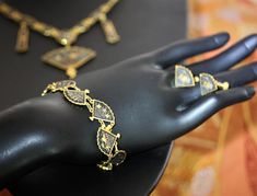 "This is truly a remarkable set in excellent vintage condition. Very nice weight and articulation. The bracelet is 7 1/2\". Earrings are screw back (typical to the age), and are 1/2\". And, the elaborately detailed necklace is 19\" with a 3\" pendant drop. Necklace is marked K24. Of similar vintage sets we have encountered, this is by far the nicest we have seen. Perfect for wear; nice enough for gifting. NOTE: We are happy to ship to our friends around the globe. Please contact us with any ques Antique Finish Adjustable Wedding Jewelry, Adjustable Antique Finish Wedding Jewelry, Elegant Bangle Jewelry With Antique Finish, Elegant Antique Finish Bangle, Antique Gold Bangle For Formal Occasions, Antique Gold Bangle Jewelry For Formal Occasions, Heavy Ornate Jewelry For Ceremonial Occasions, Ornate Heavy Jewelry For Ceremonial Occasions, Ornate Ceremonial Jewelry