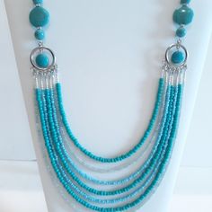 This necklace has the ability to transform any outfit into a work of art and leave an impression on those around you.  This multi layer necklace has a colorful display of mixed blue colored seed beads attached to a silver connector charm and then accented by sky blue round and flat disk beads which are alluring and eye catching.    Necklace measure 24 in. length    (Please measure for a proper fit before ordering.) Everyone has different chest and neckline sizes, which affects how the necklace w Multi Layer Necklace, Layer Necklace, Necklace Diy, Idea Board, Memory Wire, Necklace Online, Bead Jewellery, Multi Strand Necklace, Beaded Jewelry Diy