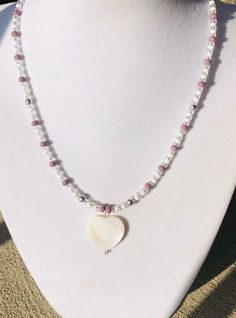 This handmade beaded necklace is made with a white heart shell pendant, Czech glass seed beads and a stainless steel lobster clasp. The heart pendant measures 19mm x 22mm and the seed beads are size 4mm & 6mm. This heart necklace comes in 16,17 or 18 inches. Please select desired length from the drop down at checkout. Seed Bead Necklaces, Handmade Beaded Necklace, Shades Of Burgundy, Bead Necklaces, Handmade Beaded Necklaces, Necklace Beaded, Shell Necklace, Seed Bead Necklace, Necklace Choker