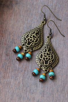 "These unique boho earrings was made of big drop shape antique brass charms, tiny czech glass \"picasso\" style blue,brown beads and antiqie brass earring hooks. Earring hooks are from nickel free and lead free metal. A wonderful jewelry for you or an unique gift for someone speacial! *The total lenght of earrings is about 67 mm including earring hooks. Other earrings of my shop you can see here: https://www.etsy.com/shop/NaTavelli?section_id=13757927 Thanks for visit." Brass Chandelier Earrings For Festivals, Brass Chandelier Drop Earrings For Festival, Antique Gold Bohemian Jewelry, Brass Dangle Chandelier Earrings For Festivals, Bohemian Metal Chandelier Earrings For Festivals, Bohemian Teardrop Beaded Earrings Nickel Free, Bohemian Metal Chandelier Earrings Nickel Free, Bohemian Earrings With Antique Finish For Jewelry Making, Bohemian Beaded Teardrop Dangle Earrings