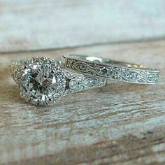 two wedding rings on top of each other with an old - fashioned style diamond in the center