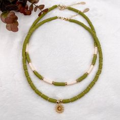 Heishi necklace, olive green necklace, Heishi boho necklace, dainty flower necklace, simple beaded necklace, summer bead necklace. These boho chic chokers are very trendy and they match with your daily outfit. If you are looking for stylish summer necklace to enhance your daily outfit, you found them! They're easy to wear everyday alone or layered with other favorite necklaces. 💕 ITEM DETAILS: Length: 14 - 16 inches. The length of the necklace refers to the total length from end-to-end. Materia Dainty Green Jewelry For Beach, Bohemian Beaded Necklace With Flower Charm For Summer, Bohemian Summer Necklace With Flower Pendant, Bohemian Flower Pendant Necklace For Summer, Green Adjustable Necklace With Flower Charm, Adjustable Green Flower Necklace With Round Beads, Dainty Green Adjustable Beaded Necklaces, Bohemian Flower Necklace With Tiny Beads, Handmade Dainty Green Necklace