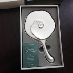 a silver spoon in a box on a table