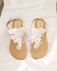 White lace bridal sandals are designed with feminine lace design. They are perfect for your Destination Wedding or a comfortable alternative for traditional brides. The comfortable wedding sandals are vegan friendly. They are perfect for wearing at your reception so you can dance the night away in comfort! After the wedding wear them all summer long. The lace is white and the sandal straps are an off white/neutral color. Additional beach inspired items can be found in my shop http://www.etsy.com Lace Wedding Shoes With Lace Work, Wedding Shoes With Lace Work, White Lace Wedding Sandals, Lace Open Toe Wedding Shoes For Bridal Shower, Lace Wedding Shoes Open Toe For Bridal Shower, Lace Open-toe Wedding Shoes For Bridal Shower, Lace Open Toe Sandals For Weddings, Cream Lace Open Toe Wedding Shoes, Elegant Lace Sandals For Summer