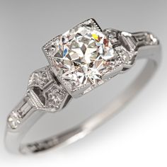 an antique style diamond engagement ring on a white background